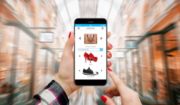 Women in mall shopping online on modern phone